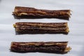 Three soft bully sticks. Dried beef esophagus ÃÂ  for pets. Horizontal layout option. White background. Shooting from above. Macro.